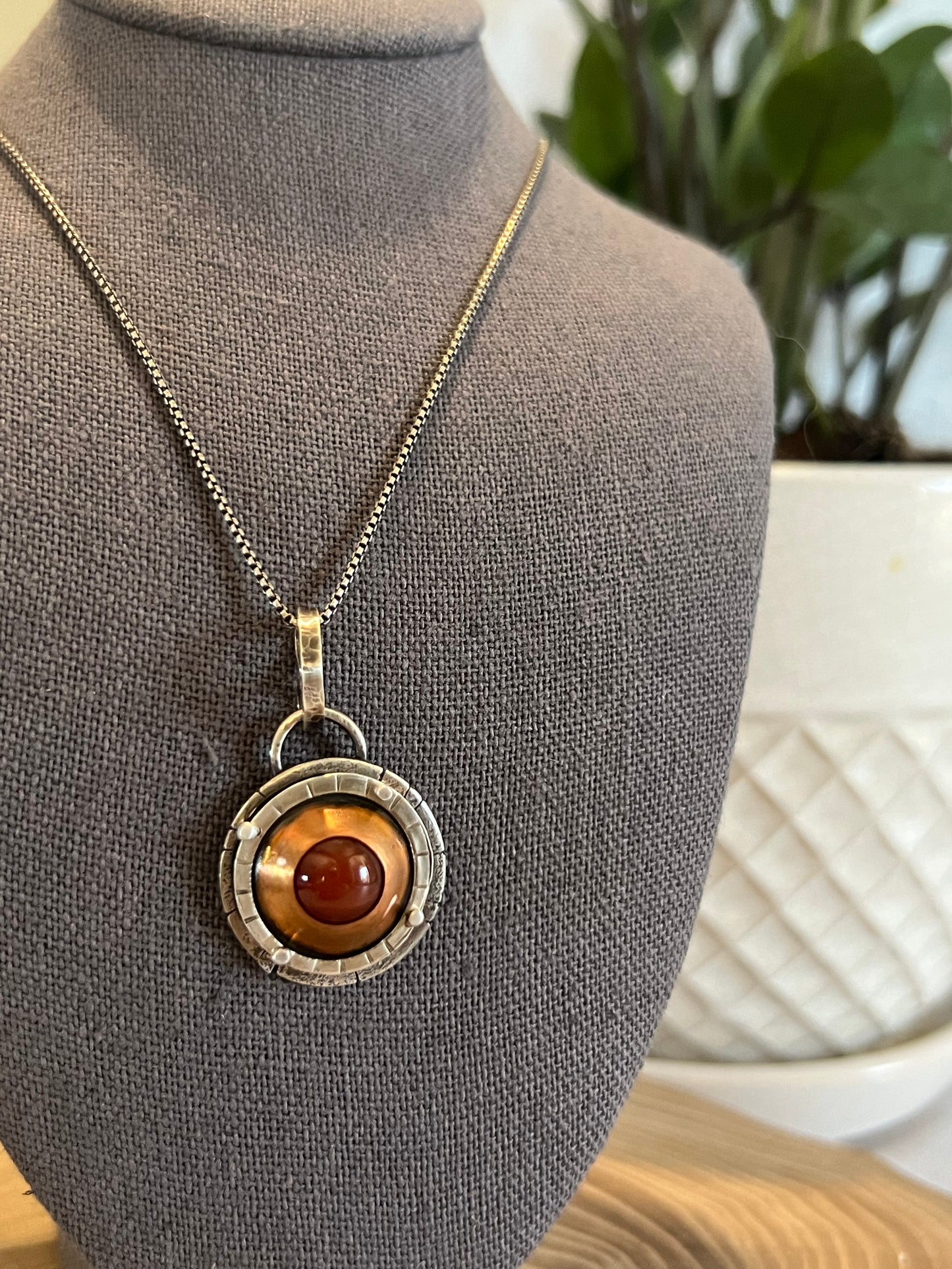 Copper carnelian adorned with sterling silver