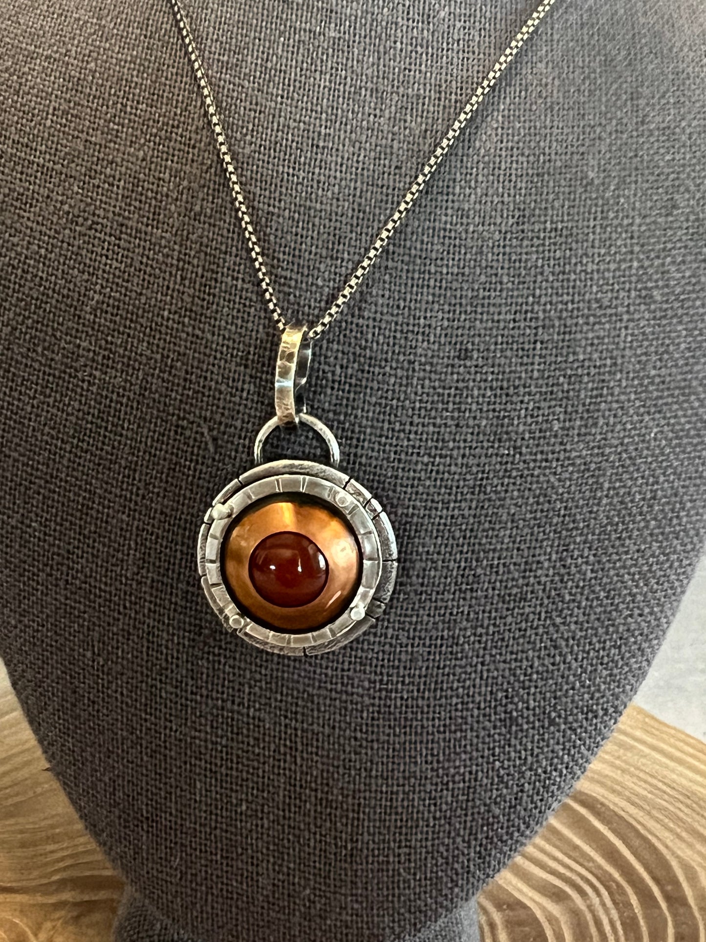 Copper carnelian adorned with sterling silver